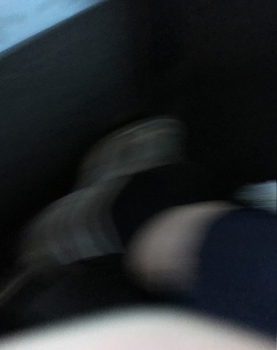 A dark and blurry photo of a foot.